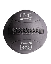 Gym Gear wall balls for fitness training, 5kg exercise balls for strength and durability, shown in a gym setting.