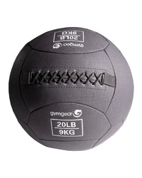 Gym Gear wall balls in 9kg for strength training, shown hanging on a wall with a textured surface and vibrant color.