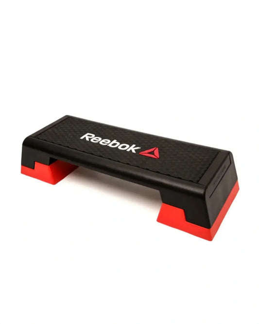 Reebok step platform for studio workouts, featuring a sturdy rectangular design with textured surface for stability.